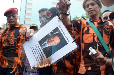 Indonesian protesters burn a picture of Tony Abbott at a rally outside the Australian embassy in Jakarta