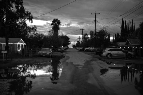 A flooded residential street at night
