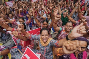 A crowd of women raising their fists in protest