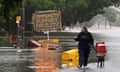 Woman walks down flooded street