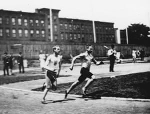 black and white photo of two men running outside