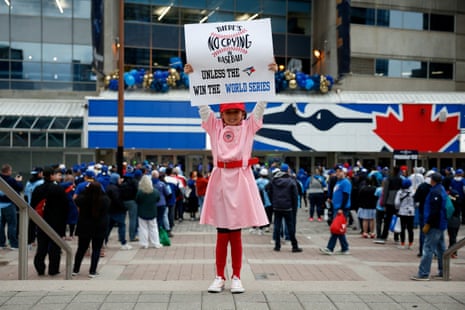 Ivy Hill holds a sign outside Rogers Centre before Game 6.