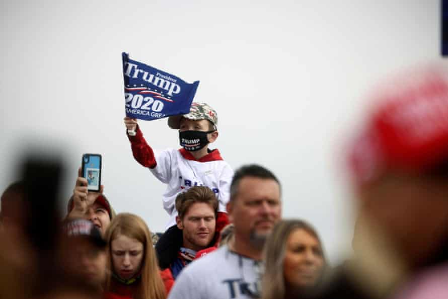 A child holds a flag as supporters wait for the rally of Donald Trump at Hickory regional airport in Hickory, North Carolina, on Sunday.