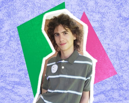 A young man wearing a grey striped polo shirt with unkempt long hair