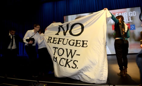 Protesters interrupt Andrew Giles speach during the boat turn back debate during the 2015 ALP National Conference at the Melbourne Convention Centre in Melbourne, Saturday, July 25, 2015. 