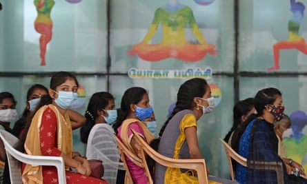 Young frontline workers wait to get vaccinated at a government hospital in Chennai