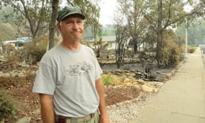 Roger Gray standing in front of his neighbor’s yard in Redding, California.