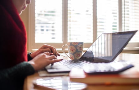 Anonymous woman on a laptop at a table