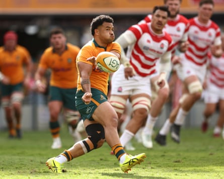 Hunter Paisami passes the ball for the Wallabies against Japan