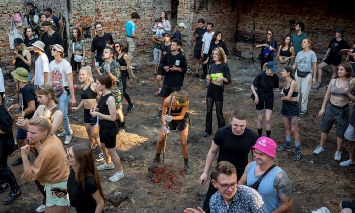 Volunteers dance after cleaning up the House of a Culture in the village of Yahidne, Chernihiv region.