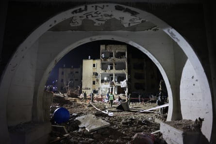 emergency workers attend a site of damaged buildings