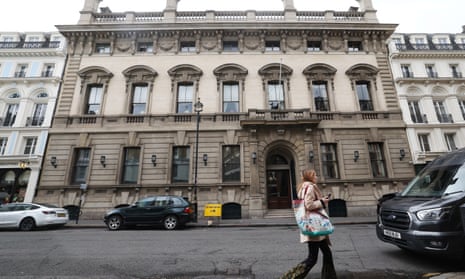 A person walks past the entrance to the Garrick Club in London