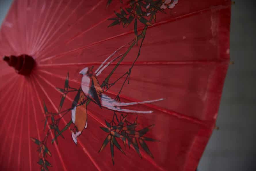 A red umbrella with a bird drawn on