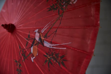 A red umbrella with a bird drawn on