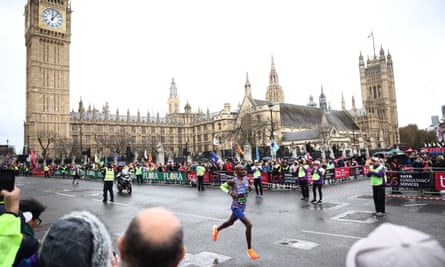 Mo Farah runs past the Houses of Parliament on his farewell London Marathon appearance.