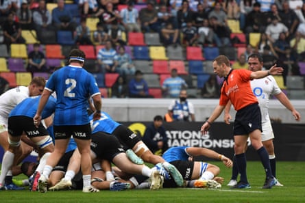 Angus Gardner points to release the ball
