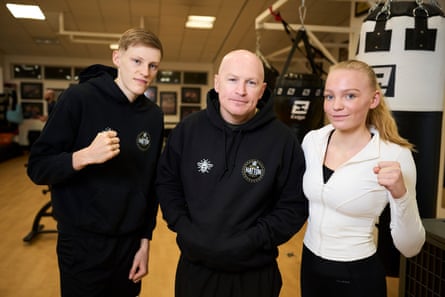 Matthew Hatton and his teenage children Lola and Jack, who pose with their fists up