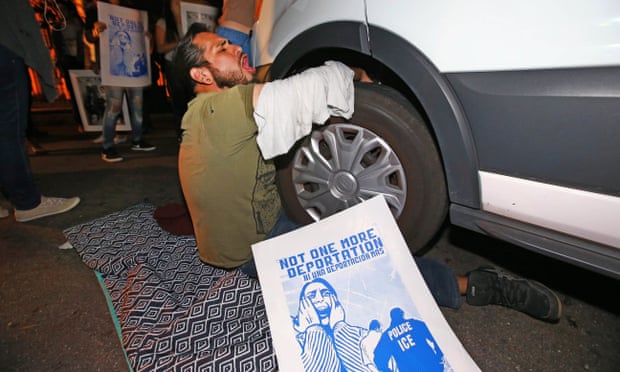 A protester locks himself to the van carrying Guadalupe Garcia de Rayos outside the Ice facility in Phoenix.