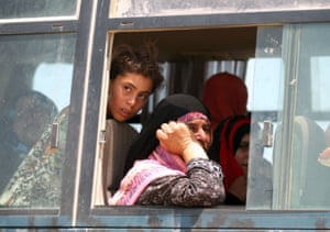 Buses take fleeing families to relative safety away from the frontlines