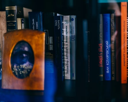 Books behind a framed portrait photo
