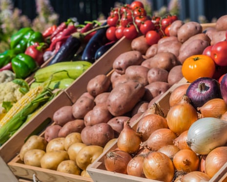 A stall with various vegetables at a farmers' market