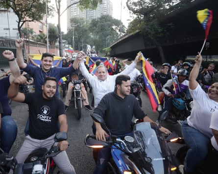 People on motorbikes celebrating in Caracas with Venezuela flags