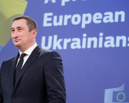 Deputy prime minister of Ukraine, Oleksiy Chernyshov, wearing a suit and standing in front of a board that reads European Ukrainians.