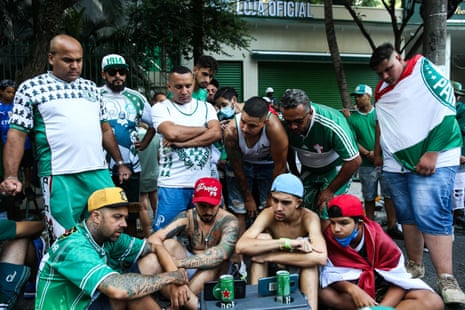 Fans of Palmeiras outside look dejected.