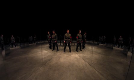 Still from film showing projected images of Nazi soldiers standing in a circle in dark room