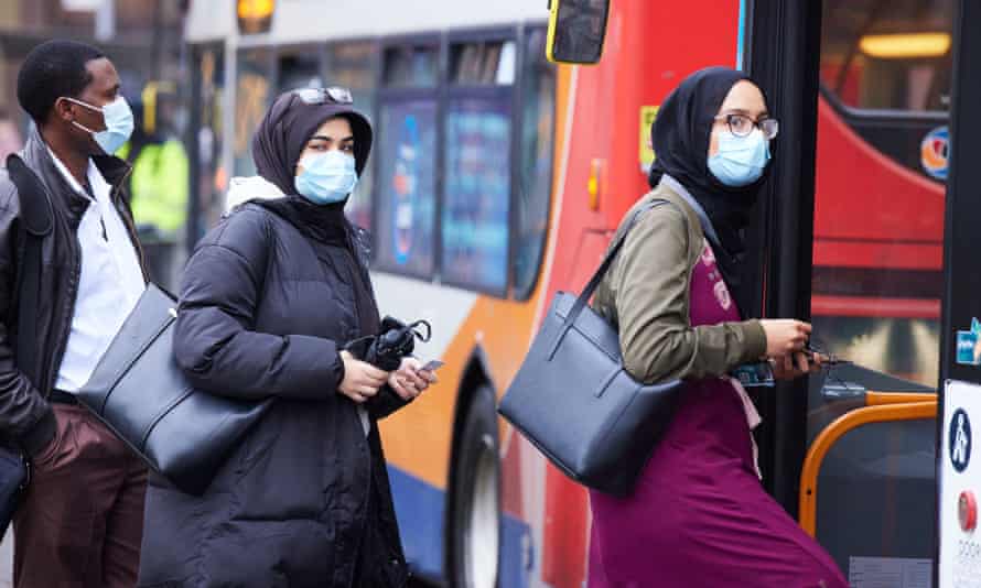 Passengers board a bus in Manchester on Tuesday.