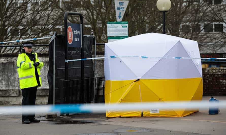 A police officer stands guard by a forensics tent in Salisbury