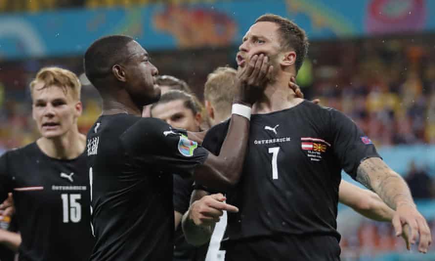 David Alaba intervenes as Marko Arnautovic celebrates his goal against North Macedonia.