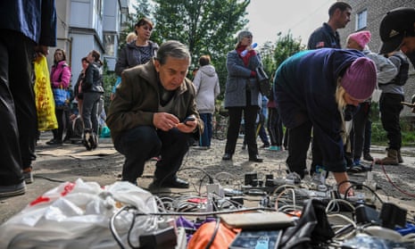 Residents charge their mobile phones outside a humanitarian centre in Izium, eastern Ukraine.
