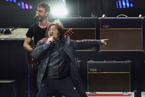 Javier Milei animatedly singing into a microphone