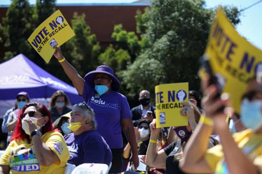 Supporters hold up signs in support of Gavin Newsom at a Stop the Recall rally in Oakland, California, on 11 September.