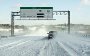 A single driver navigates MoPac Boulevard on the bridge over Lady Bird Lake after a heavy snow on Monday, Feb. 15, 2021, in Austin, Texas.
