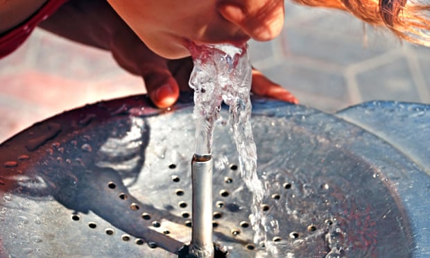 Person drinking from water fountain.