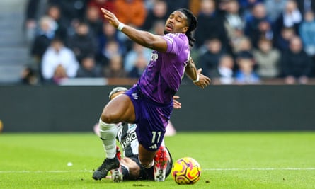 Joelinton tries to stop Adama Traoré by foul means or fair.