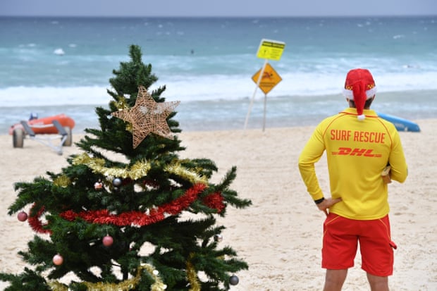 A surf lifesaver is seen on a windy and rainy Christmas Day on Bondi Beach on Friday.