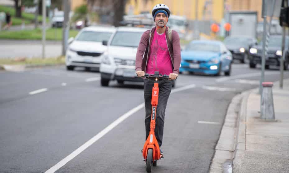James Norman riding an e-scooter at St Kilda, Melbourne Australia.