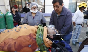 Paramedics transport a man injured during clashes with security forces to a hospital in El Alto on Tuesday.
