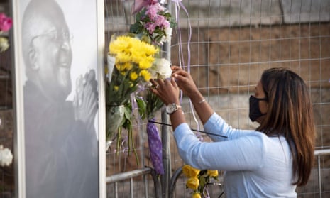 A mourner brings flowers to St George’s Cathedral, Cape Town.