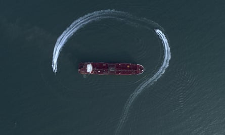 In this 21 July photo, an aerial view shows a speedboat of Iran’s Revolutionary Guard moving around the British-flagged oil tanker Stena Impero. Iran has stepped up harassment of oil shipping.