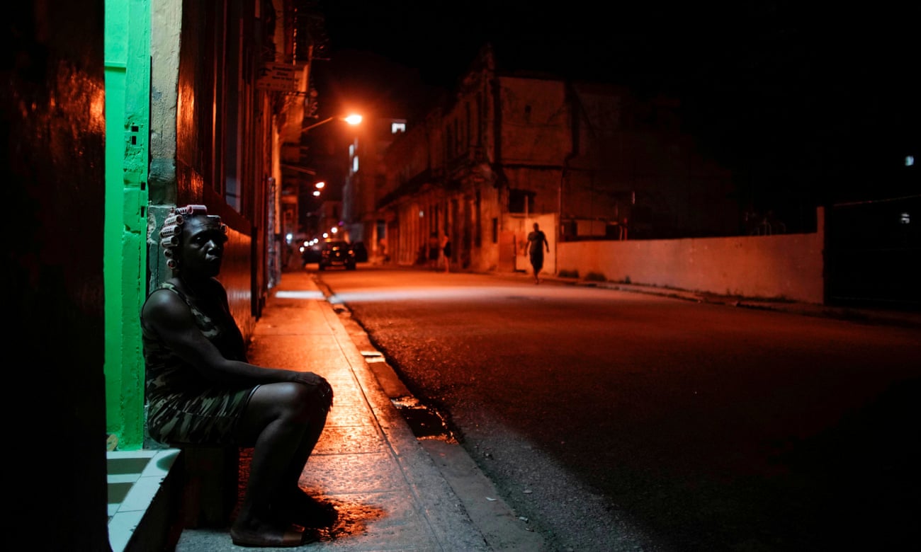 Zoraide Hernandez sits at her doorstep for fresh air in Havana, Cuba, this week.