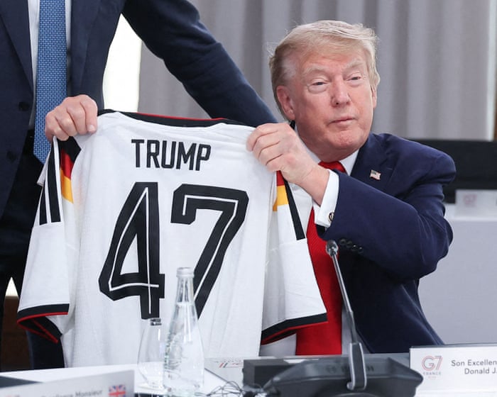 German chancellor Merz gifts Trump football shirt at G7 – video