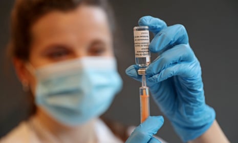 A pharmacist prepares to administer the Oxford/ AstraZeneca vaccine in London.