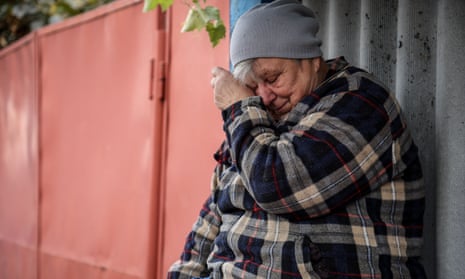 Alla, a local resident, cries near her home two days after a military strike hit the village of Hroza