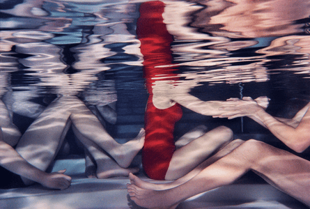 People sitting on the bottom of a swimming pool