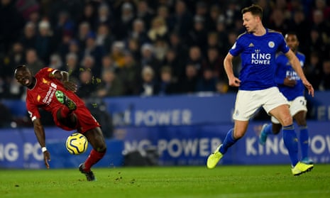 Sadio Mane of Liverpool can’t reach the ball as Leicester’s Jonny Evans looks on.