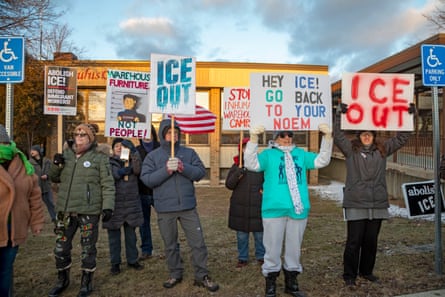 people hold signs against the agency ICE